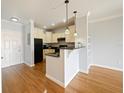 Modern kitchen with granite countertop and hardwood floors at 202 E South St # 6042, Orlando, FL 32801