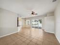 Spacious living area with tile flooring and views to the kitchen and backyard at 6311 Alamanda Hills Dr, Lakeland, FL 33813