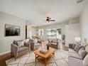 Bright and airy living room featuring comfortable seating and access to a backyard patio at 6311 Alamanda Hills Dr, Lakeland, FL 33813