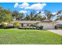 House exterior showcasing a well-maintained lawn and landscaping at 734 Riverbend Blvd, Longwood, FL 32779