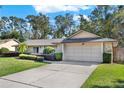 House exterior showcasing a well-maintained lawn and landscaping at 734 Riverbend Blvd, Longwood, FL 32779