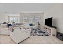Spacious living room with comfortable seating and large TV at 1092 Downswing Pl, Davenport, FL 33896