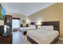 Double bedroom with two beds, a TV and ample closet space at 3000 Maingate Ln # 113, Kissimmee, FL 34747