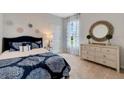 Cozy bedroom with patterned bedding and neutral decor at 1771 Three Bars Rd, Kissimmee, FL 34744