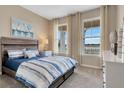 Bright bedroom with lake view, wood-like flooring and window treatments at 1771 Three Bars Rd, Kissimmee, FL 34744