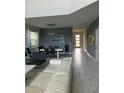 Open living and dining area with white sectional sofa at 2813 Bookmark Dr, Kissimmee, FL 34746