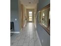 Elegant entryway with tiled floor and modern console table at 2813 Bookmark Dr, Kissimmee, FL 34746