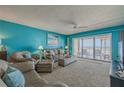 Ocean view living room with comfy seating and sliding glass doors at 5501 S Atlantic Ave # 307, New Smyrna Beach, FL 32169