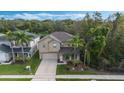 Two-story house situated on a residential street with lush green landscaping at 12730 Oulton Cir, Orlando, FL 32832