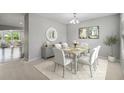 Bright dining room with table, chairs, and view into living area at 1546 Water Elm Ct, Orlando, FL 32825