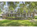 Two-story home with stone accents and a large front porch at 25821 Feather Ridge Ln, Sorrento, FL 32776