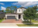 Two-story house with solar panels and landscaped yard at 5443 Carrara Ct, St Cloud, FL 34771