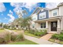 Row of townhouses with similar design, landscaping, and brick walkways at 8948 Hildreth Ave, Orlando, FL 32832