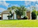 Brick house with a white front door and a well-maintained lawn at 125 Grand Junction Blvd, Orlando, FL 32835