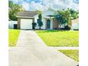 House with a driveway and a nicely landscaped front yard at 125 Grand Junction Blvd, Orlando, FL 32835