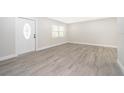 Bright living room featuring new laminate flooring and fresh paint at 3703 Wade Rd, Orlando, FL 32808