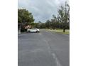 Asphalt road with mature trees and parked car at 4229 S Lake Orlando Pkwy # 133, Orlando, FL 32808