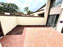 Brick patio with mulch landscaping and sliding door access at 4229 S Lake Orlando Pkwy # 133, Orlando, FL 32808
