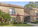 Exterior view of condo building with balcony, screened porch, and landscaping at 429 Sheoah Blvd # 2, Winter Springs, FL 32708