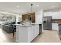 Open kitchen with island, stainless steel appliances, and granite countertops at 4306 Lana Ave, Davenport, FL 33897