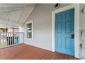 Front porch with blue door, wood flooring and white railings at 709 Jernigan Ave, Orlando, FL 32805