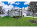 Side view of a single-Gathering home with a fenced backyard and lush lawn at 3759 Rory Oak Cir, Apopka, FL 32703