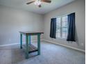 Spacious bedroom with carpeted floor, window with curtains, and ceiling fan at 911 Avenal, Davenport, FL 33837