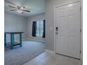 Bright entryway with tile flooring, a white door and a rustic table at 911 Avenal, Davenport, FL 33837