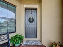 Inviting front door entryway with a charming wreath at 941 Rimini Dr, Saint Cloud, FL 34771