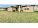 Large backyard with a patio and plenty of green space at 941 Rimini Dr, Saint Cloud, FL 34771