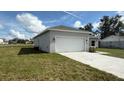 Attached garage with a driveway, offering ample parking space at 2427 Continental Blvd, Orlando, FL 32808