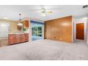 Bright living room with brick accent wall and view of backyard patio at 2900 Lake Arnold Pl, Orlando, FL 32806