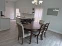 Dining room with a round table, six chairs, and a view into the kitchen at 4612 Cheyenne Point Trl, Kissimmee, FL 34746