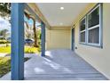 Renovated front porch with light-grey wood floors and blue columns at 1020 W Line St, Leesburg, FL 34748