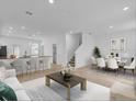 Open living room and kitchen with modern island and dining area at 11209 Listening Dr, Orlando, FL 32832