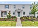 Two-story townhome with a stone accent and landscaped walkway at 11209 Listening Dr, Orlando, FL 32832