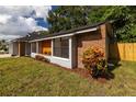 Side view of brick house with well-maintained landscaping at 1819 Stafford Dr, Belle Isle, FL 32809