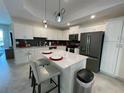 Modern kitchen with white cabinets and a large island at 3161 Paradox Cir # 301, Kissimmee, FL 34746
