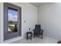 Small front porch with chair and side table at 3361 Private Oak Dr, Apopka, FL 32703