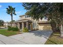 Two-story house with stone columns and landscaping at 4204 Oakview Dr, Davenport, FL 33837