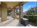 Covered porch with stone columns and storage container at 4204 Oakview Dr, Davenport, FL 33837