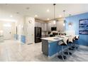 Modern kitchen with gray cabinets, white countertops, and stainless steel appliances at 8843 Interlocking Ct, Davenport, FL 33896