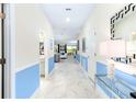 Bright entryway with light tile floors and blue and white color scheme at 8843 Interlocking Ct, Davenport, FL 33896