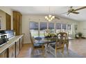 Bright dining room with a glass table and wood cabinets at 1021 Dustin Dr, Lady Lake, FL 32159