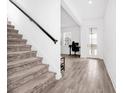 Modern staircase with carpet runner and tile flooring at 11648 Paragraph Rd, Orlando, FL 32832