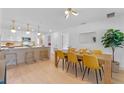Modern kitchen with white cabinets, quartz countertops, and gold accents at 1795 Walker Ave, Winter Park, FL 32789