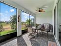 Enjoy a relaxing screened patio with seating area, overlooking a tranquil backyard at 3286 Hanging Tide St, Winter Garden, FL 34787