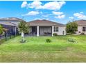 Spacious backyard with covered patio and lush green lawn at 3286 Hanging Tide St, Winter Garden, FL 34787