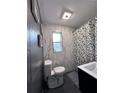 Modern bathroom with marble tile, a shower/tub combo and stylish decor at 637 Ash Ave, Daytona Beach, FL 32117