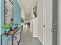 Bright entryway with a console table, mirror, and view to dining area at 684 Preston Cove Dr, St Cloud, FL 34771